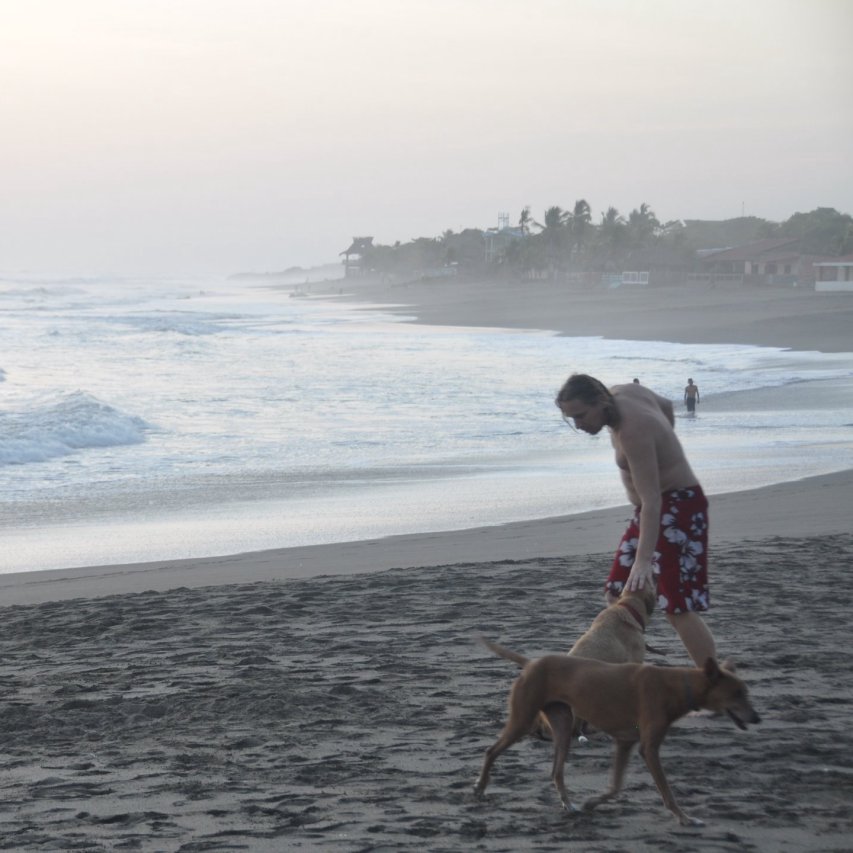 Man with dog on beach in Las Penitas