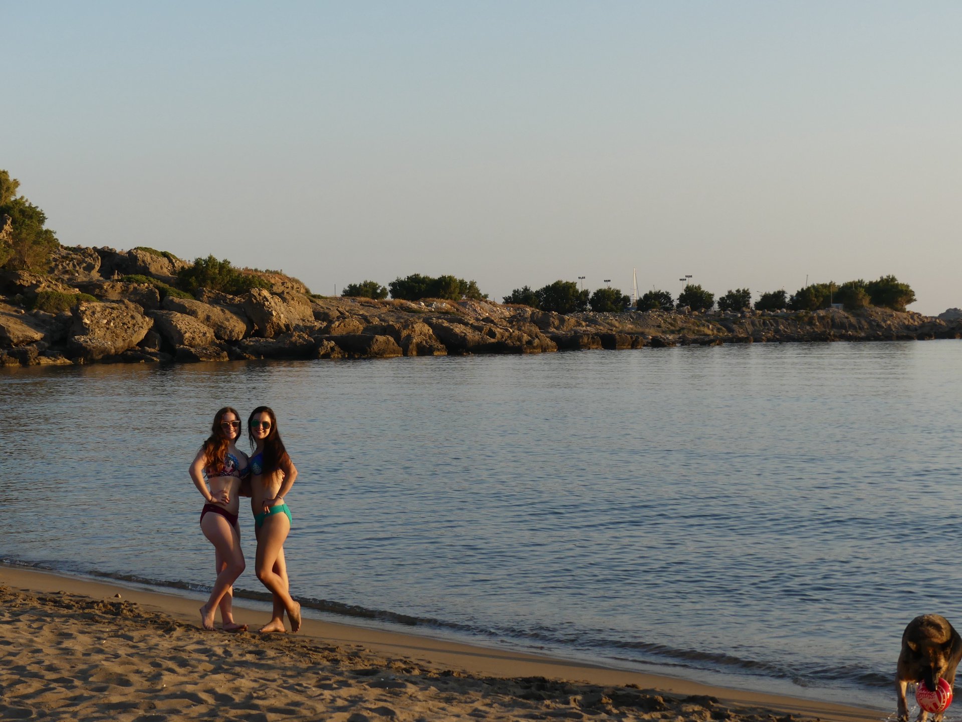 Madeline and Emily in bikinnis on Palaiochora beach at sunset posing together in sunglasses. Crete